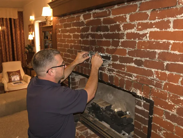 Aurora Chimney Sweep expert fixing a fireplace in Aurora, OH